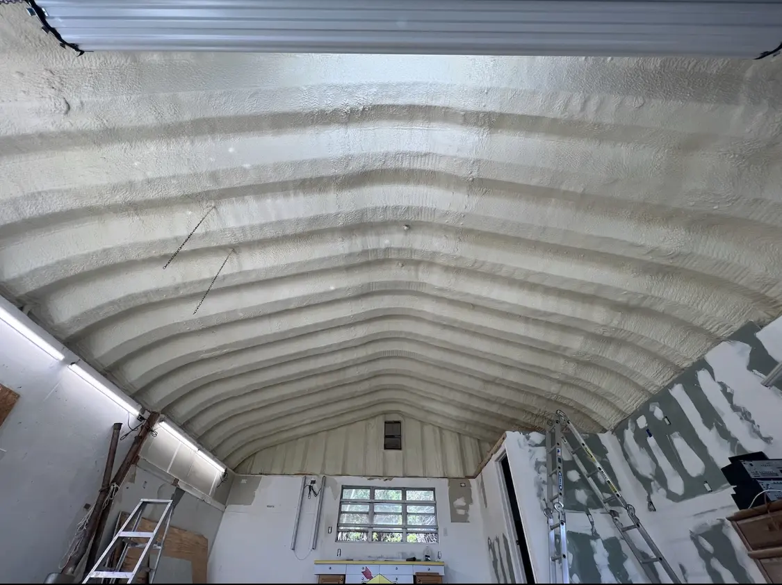 Spray polyurethane foam applied to the underside of a metal roof deck in Alexandria